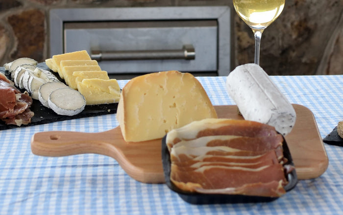 MOUNTAIN CHARCUTERIE - 2 Cave Aged Cheeses with Prosciutto on Cutting Board