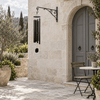 Dream Maker 64-inch Truillusion Black wind chime in a limestone courtyard